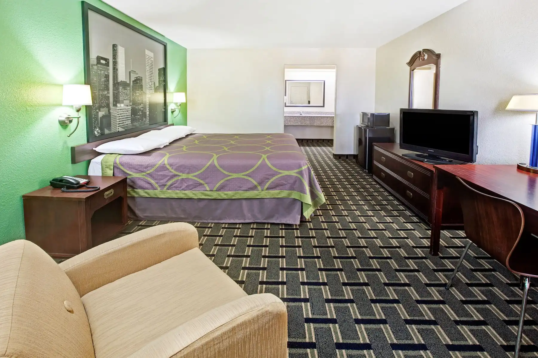 Deluxe room at Hotel Blue Baytown with king bed and lounge area